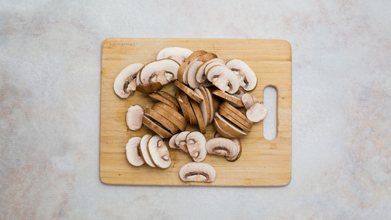 sliced mushrooms on wooden board