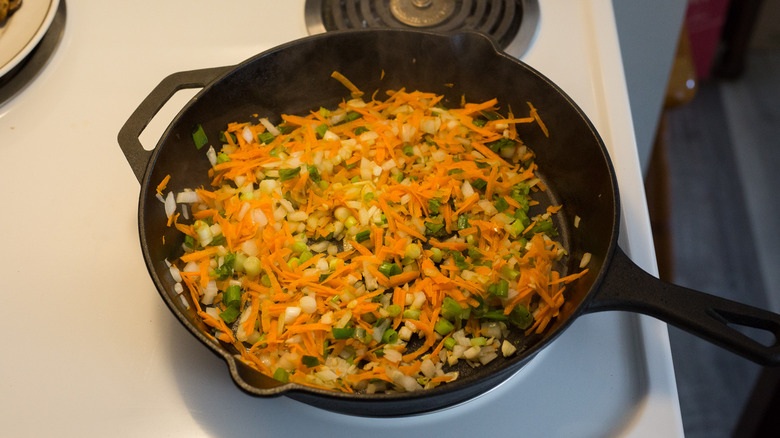 vegetables cooking in iron pan