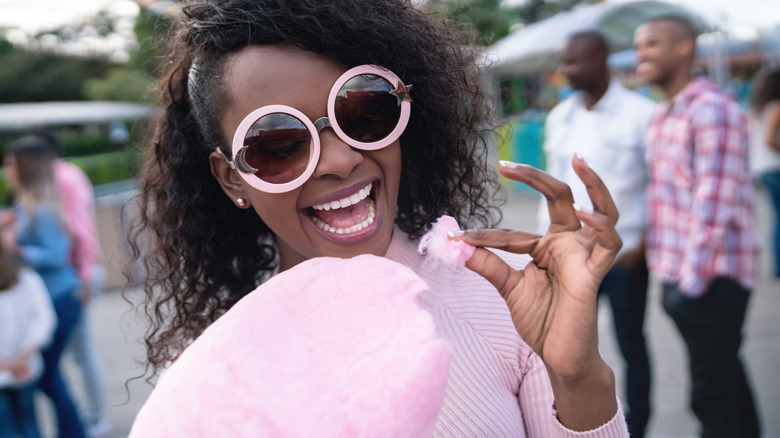 woman eating cotton candy