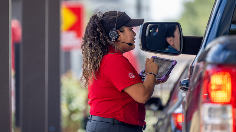 Chick-Fil-A employee taking drive-thru order