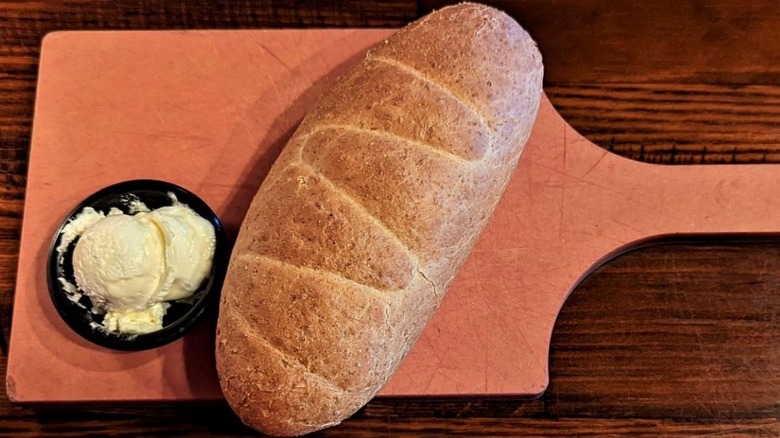 Longhorn Steakhouse bread on a cutting board with butter