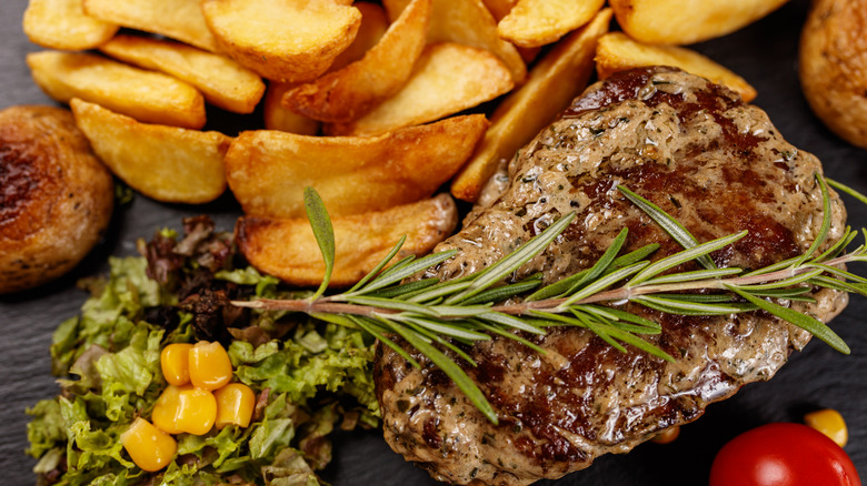 steak with fries and rosemary
