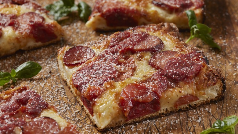 Cut slice of Detroit-style pizza