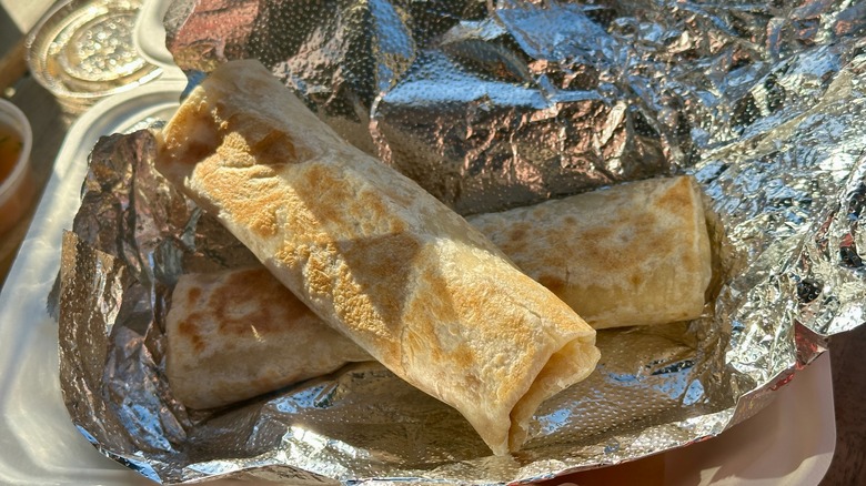 Two thin burritos in aluminum foil