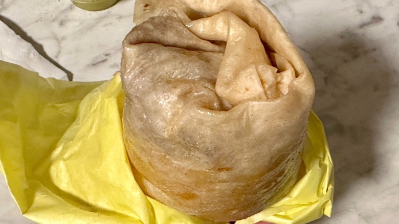 Closeup on a burrito in yellow paper