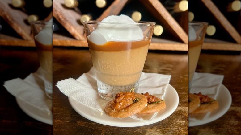 Butterscotch budino on a plate with two cookies
