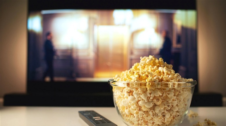 TV screen behind bowl of popcorn