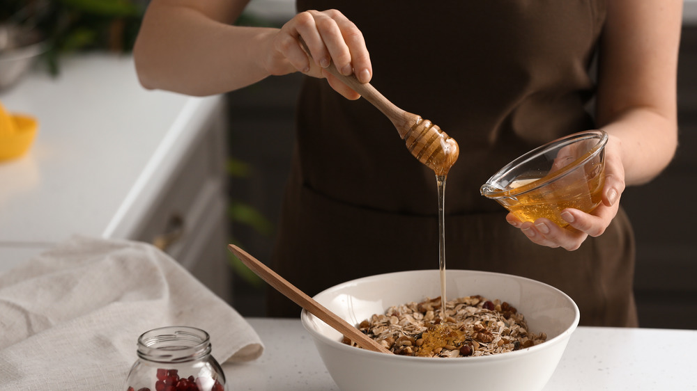 making homemade granola bars with honey and oats 