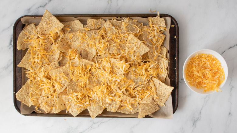 tortilla chips and cheese in a baking pan