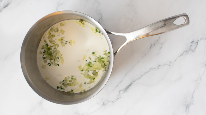 vegetables and white liquid in a metal pot