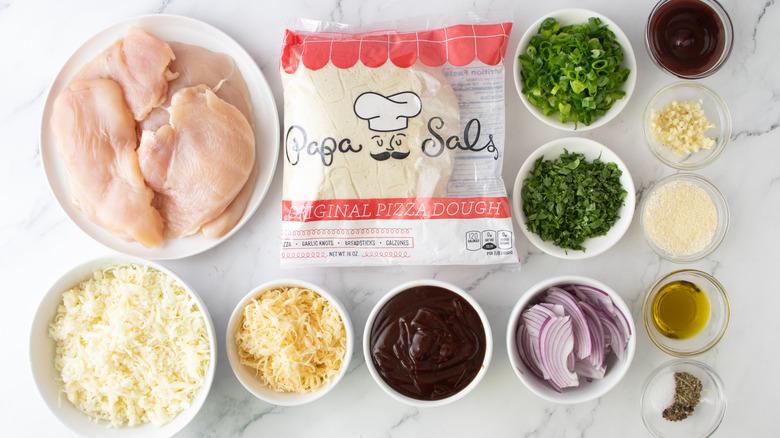 raw chicken, shredded cheese, barbecue sauce, pizza dough, seasonings, and vegetables