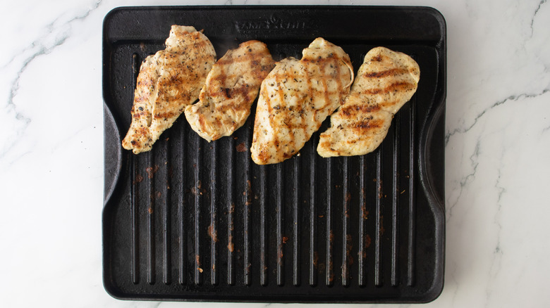 cooked chicken on a stovetop grill pan