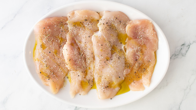 raw chicken on a white plate