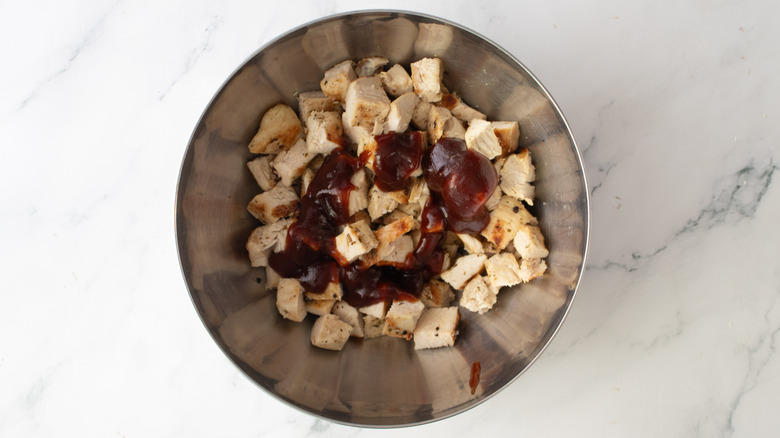 chicken and barbecue sauce in a metal bowl