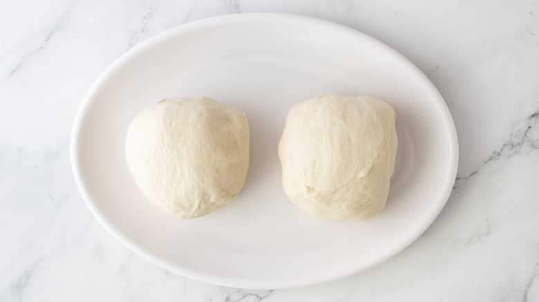 two balls of dough on a white plate