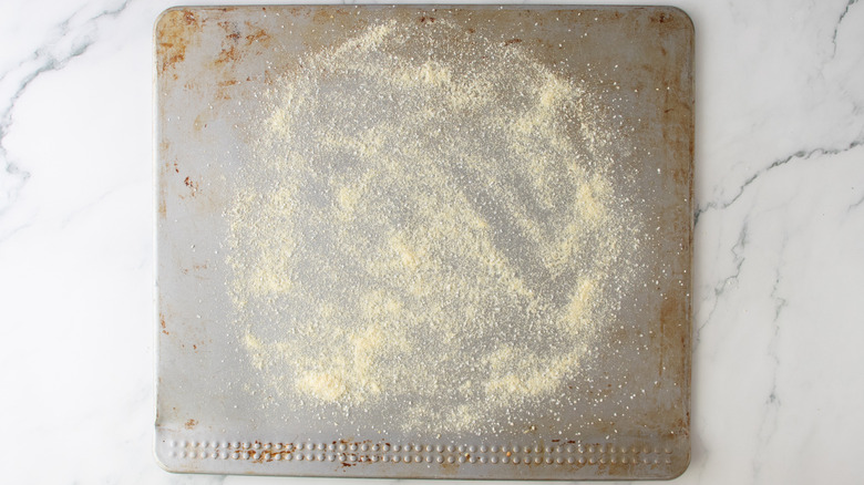 cornmeal on a sheet pan