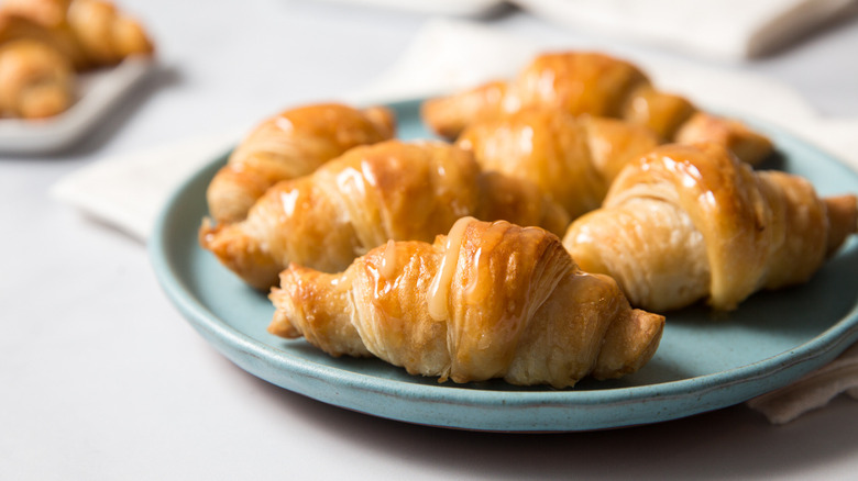 shiny croissants on blue plate
