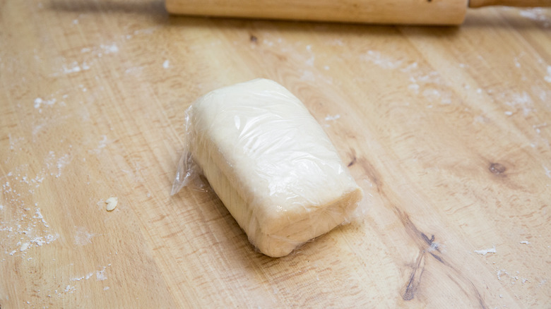 folded dough on wooden table