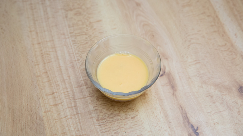 egg wash on wooden table