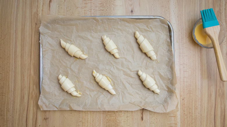 unbaked croissants on baking sheet