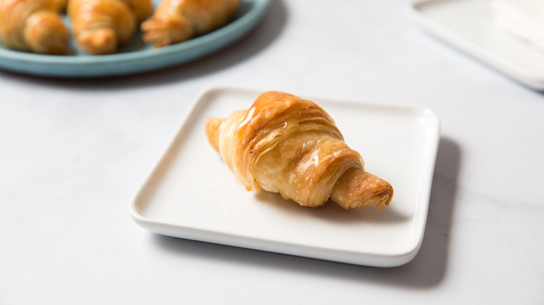 shiny croissants on blue plate