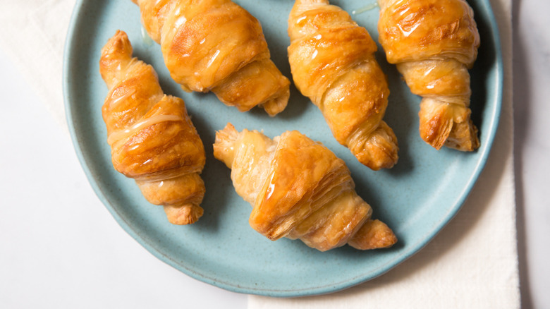 flaky croissant on white plate
