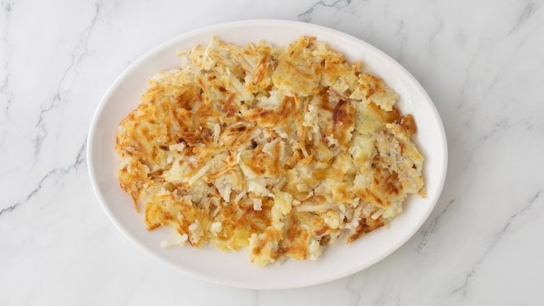 Aerial view of cooked hash browns on serving platter