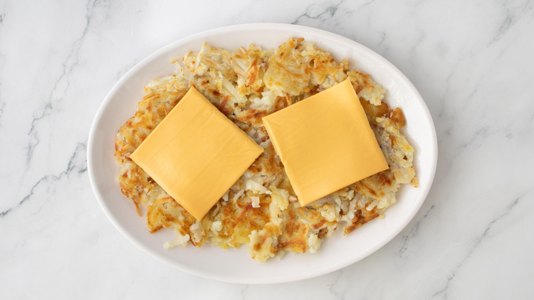 Hash browns on serving platter with American cheese on top