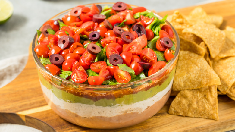 A seven-layer dip served with tortilla chips