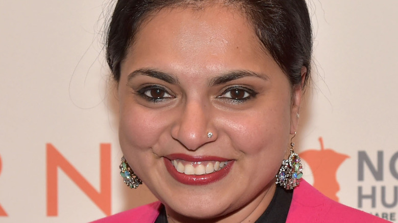 Maneet Chauhan smiling wearing earrings and pink top