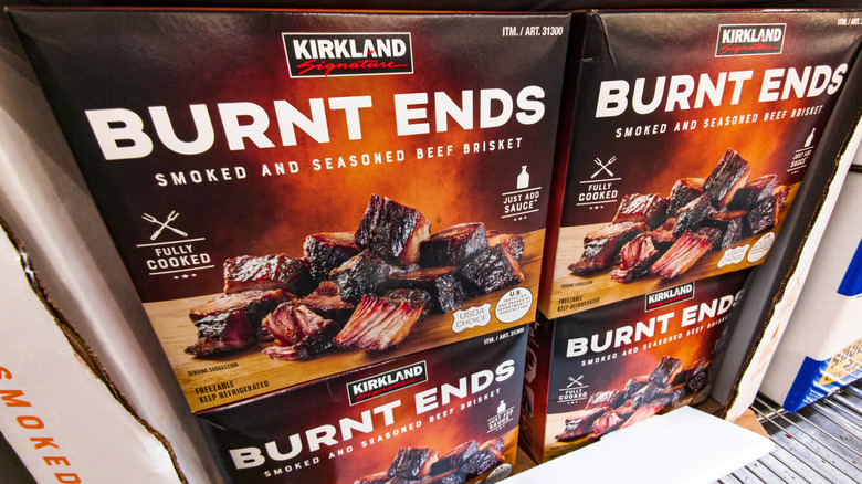 Orange and black boxes of Kirkland Signature burnt ends in a Costco warehouse store