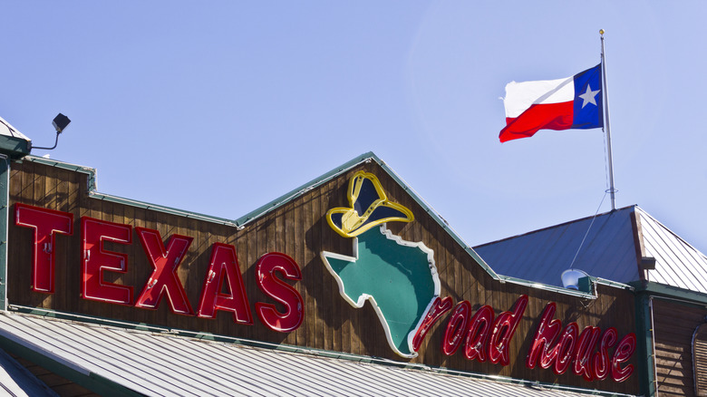 Texas Roadhouse sign and flag