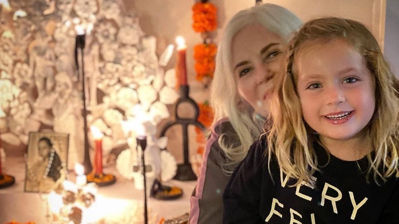 Marcella Valladolid's aunt and daughter in front of her mom's Day of the Dead altar