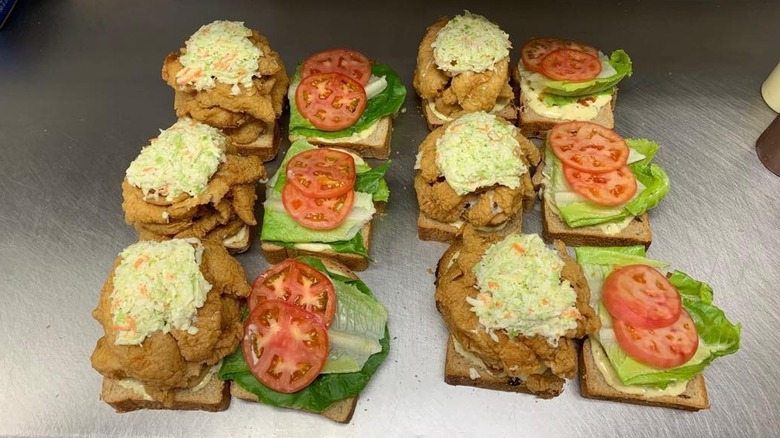 Art Mel's Spicy Dicy fish sandwiches assembled on toast on stainless steel surface