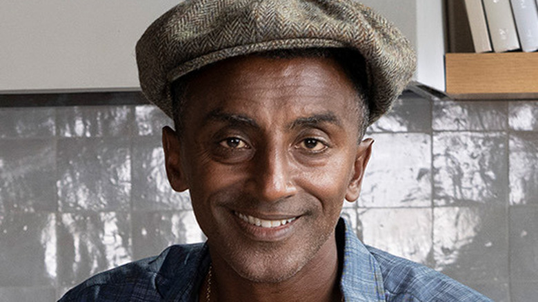 Chef Marcus Samuelsson in a hat smiling