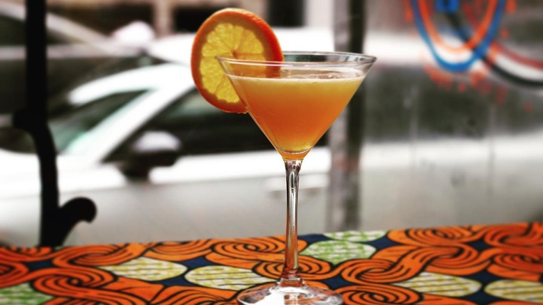 orange cocktail in martini glass