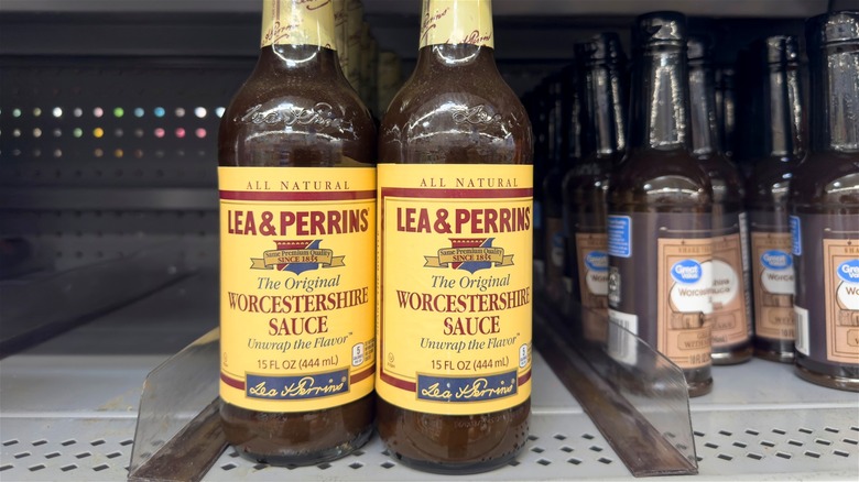 Bottles of Worcestershire sauce on a grocery shelf.