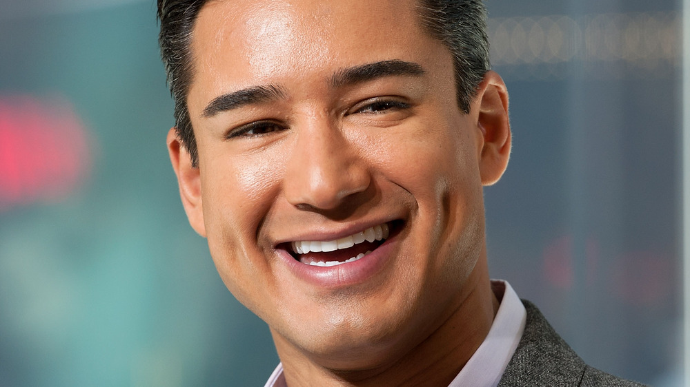 Mario Lopez smiling in suit