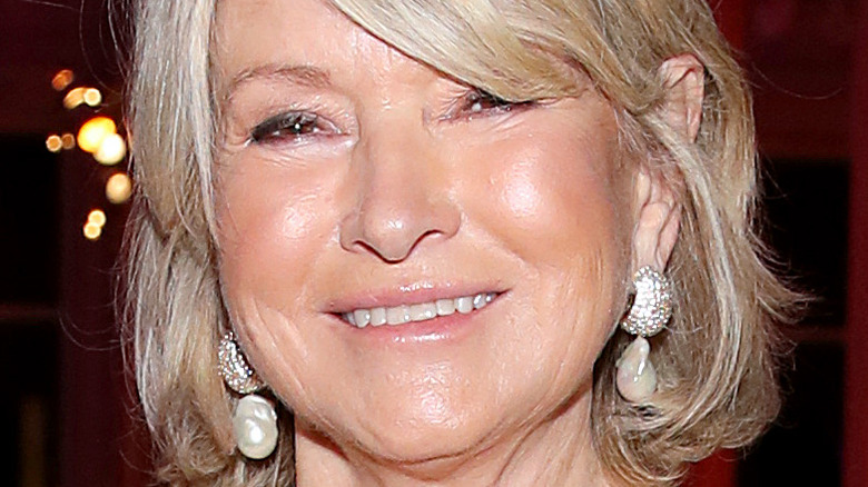 Martha Stewart with wide smile and dangling pearl earrings