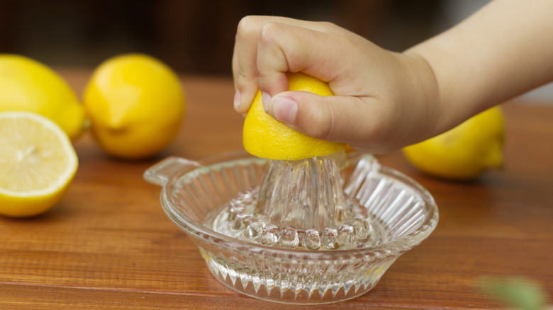 Person juicing a lemon