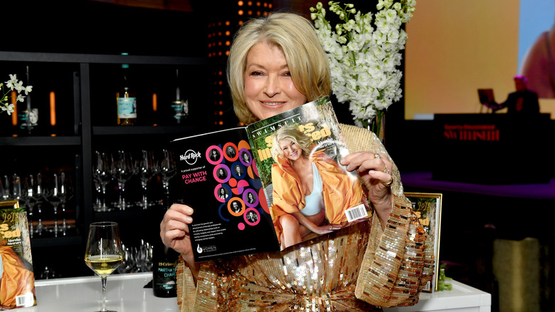 Martha Stewart holding up an issue of Sports Illustrated with herself on the cover