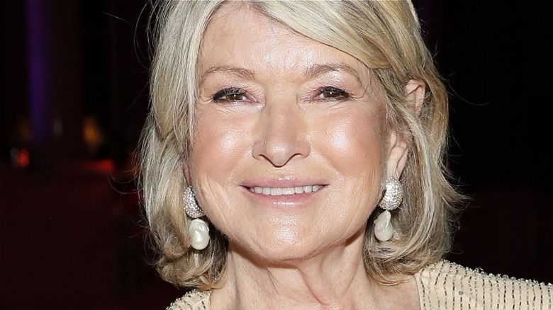 Martha Stewart with wide smile and dangling pearl earrings