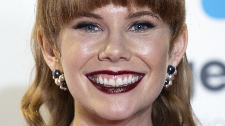 Mary Berg smiling with bangs and red lipstick