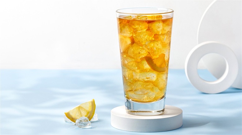 iced tea in glass on white coaster with lemon wedge