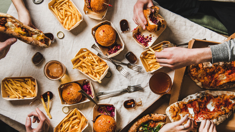 table full of multiple burgers