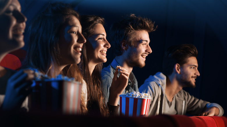 young people eating movie popcorn