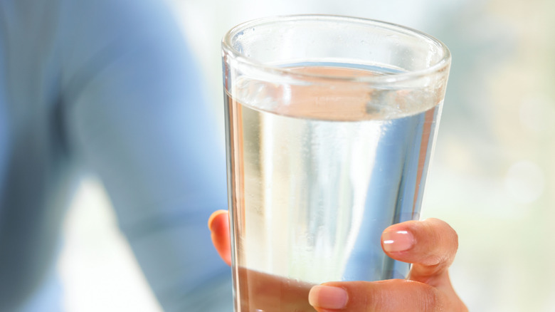 person holding a glass of water