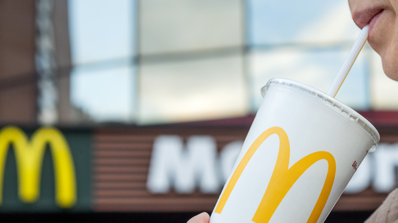 Person drinking a McDonald's beverage