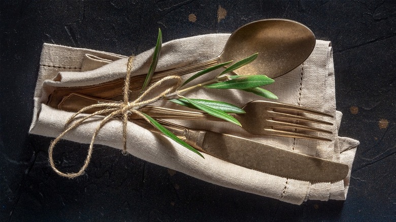 Gold silverware on napkin