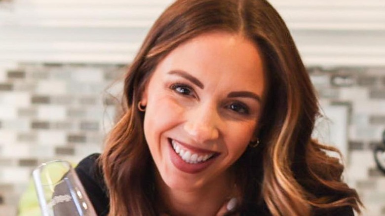 Chef Kelsey Murphy smiling with wine glass